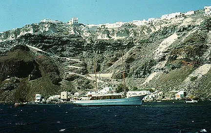 Inlet of Santorini coast with tall walls of exposed tephra