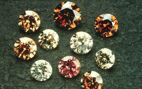 Ten round cut diamonds arranged on a green-gray background