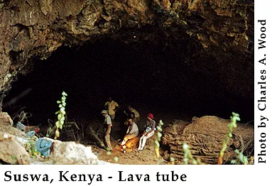 Group of people adventuring into a dark cave