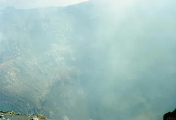 The active crater during the rare moments when the fume cleared. Note that another small eruption is beginning deep inside the crater.