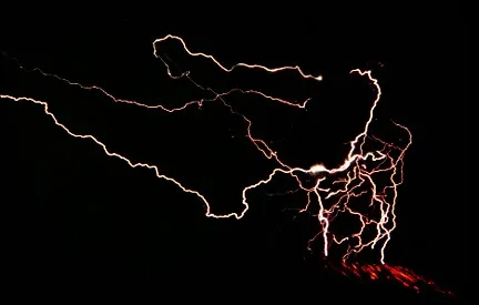 Lightning above the summit and glowing pyroclasts on the flank of Galunggung