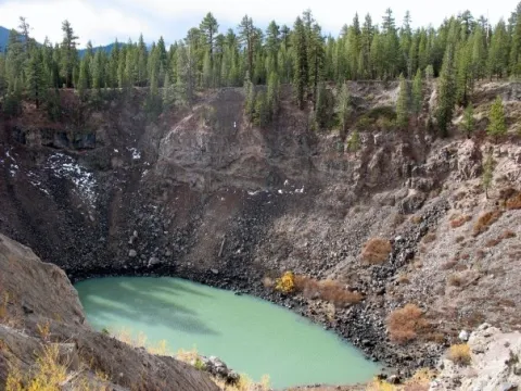 Deep and rocky Inyo crater containing turquoise water