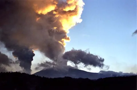 Column of smoke and ash emitting from volcano etna