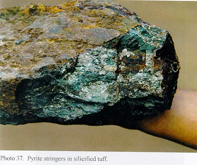 Pyrite with blue-green flecks and muddy brown exterior