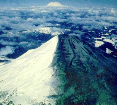 A  view to the north of the two tone mountain - an appearance  produced by  prevailing easterly winds during the initial activity of  Mount St.  Helens. Mount Rainier is visible in background. Photo by C.  Dan Miller,  USGS 